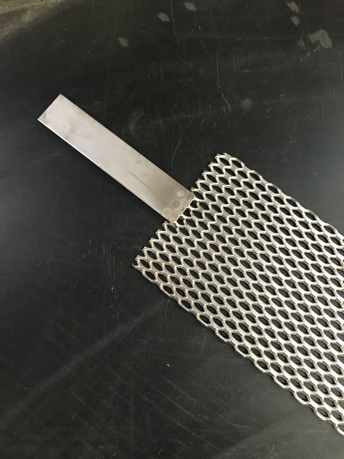 Qty Of One (1) Titanium Mesh for Anodizing or Plating. .078″ thick with Lug