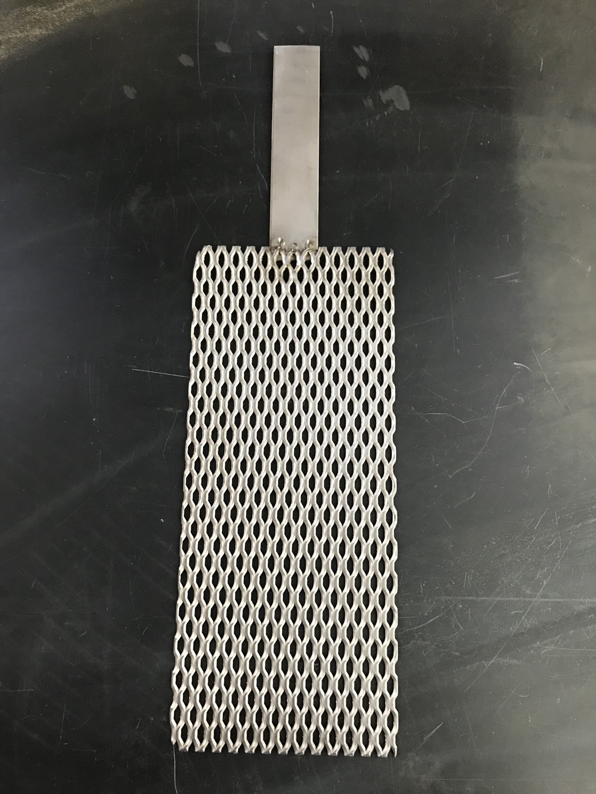 Qty Of One (1) Titanium Mesh for Anodizing or Plating. .078″ thick with Lug