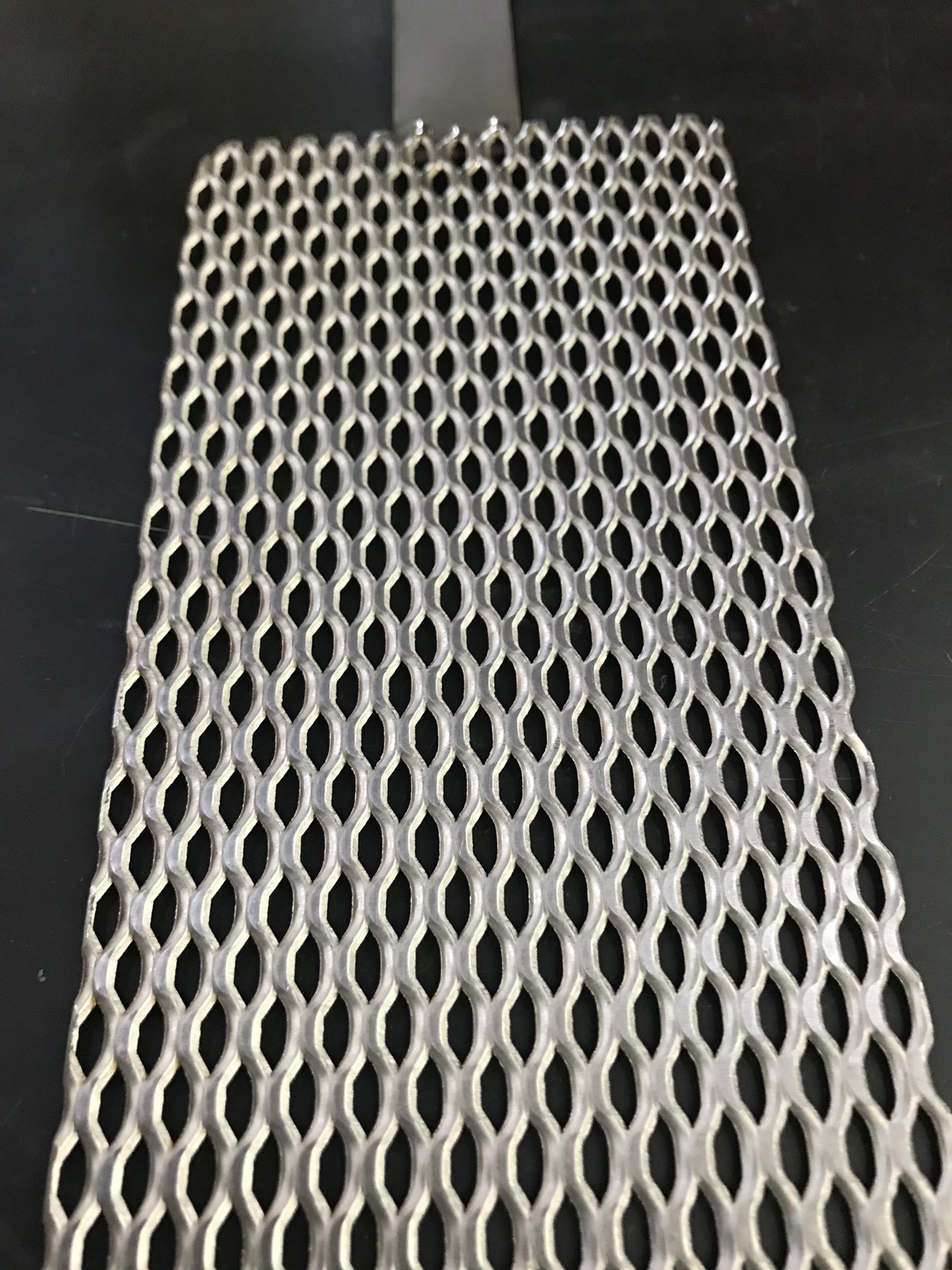 Qty Of One (1) Titanium Mesh for Anodizing or Plating. .078″ thick with Lug